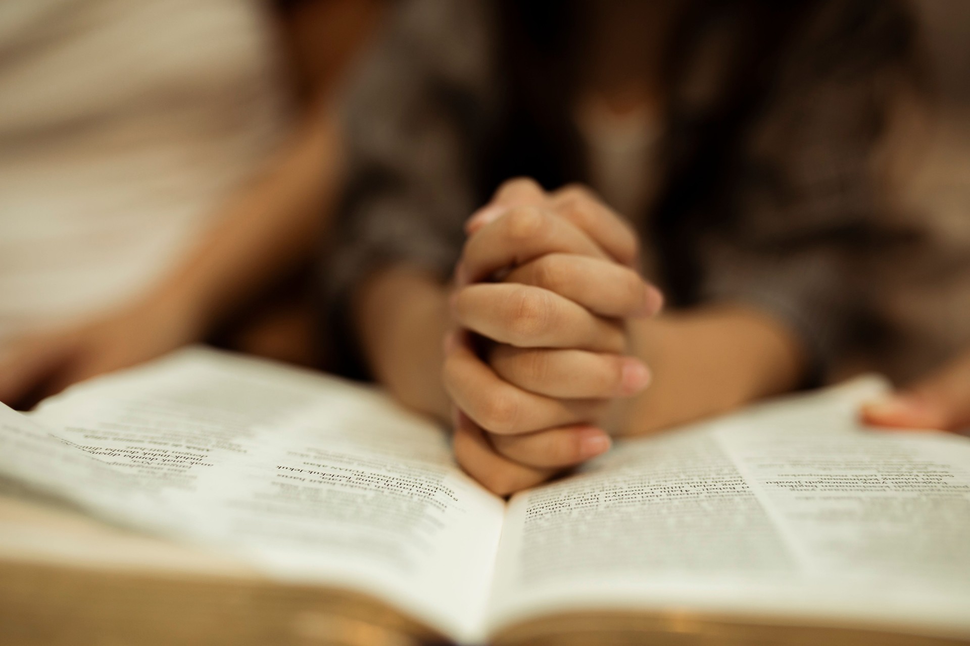 a kid reading the holy bible